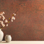 Blossom branch in clay vase near beige stucco wall background. I